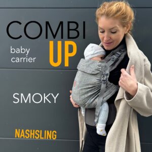 A imagem apresenta um sling de argolas na cor cinza "Smoky", feito de um tecido macio e flexível. O bebé está posicionado de forma segura e confortável, apoiado na parte da frente do adulto, que está a usar o sling de maneira prática. O design permite fácil ajuste, proporcionando suporte tanto para o bebé como para quem o transporta.